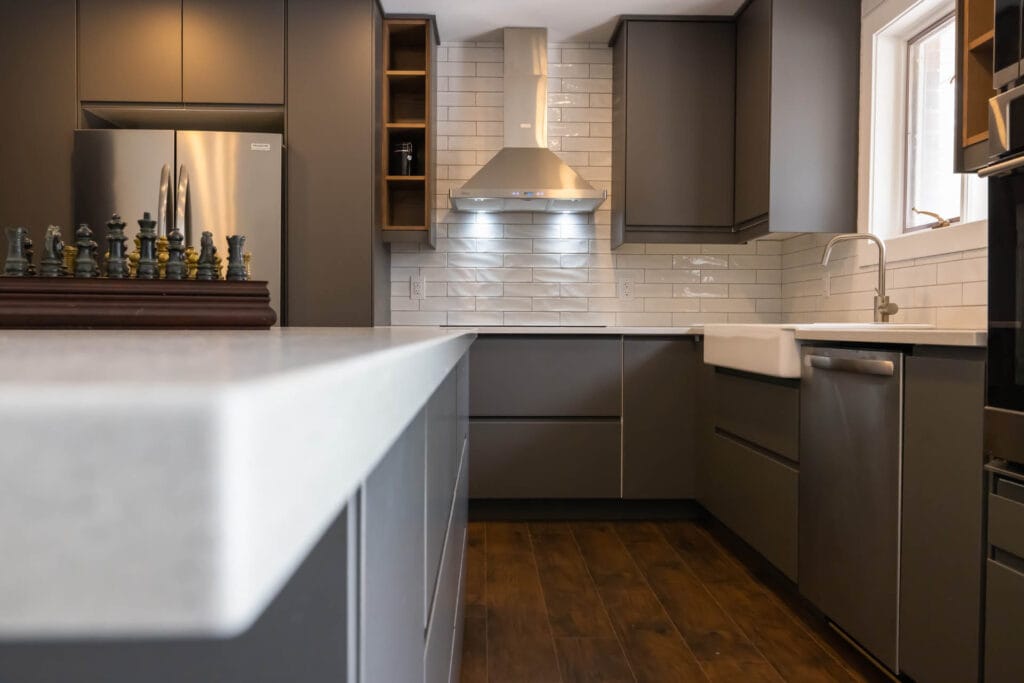 Counter top leading to kitchen cabinets backsplash and vent hood