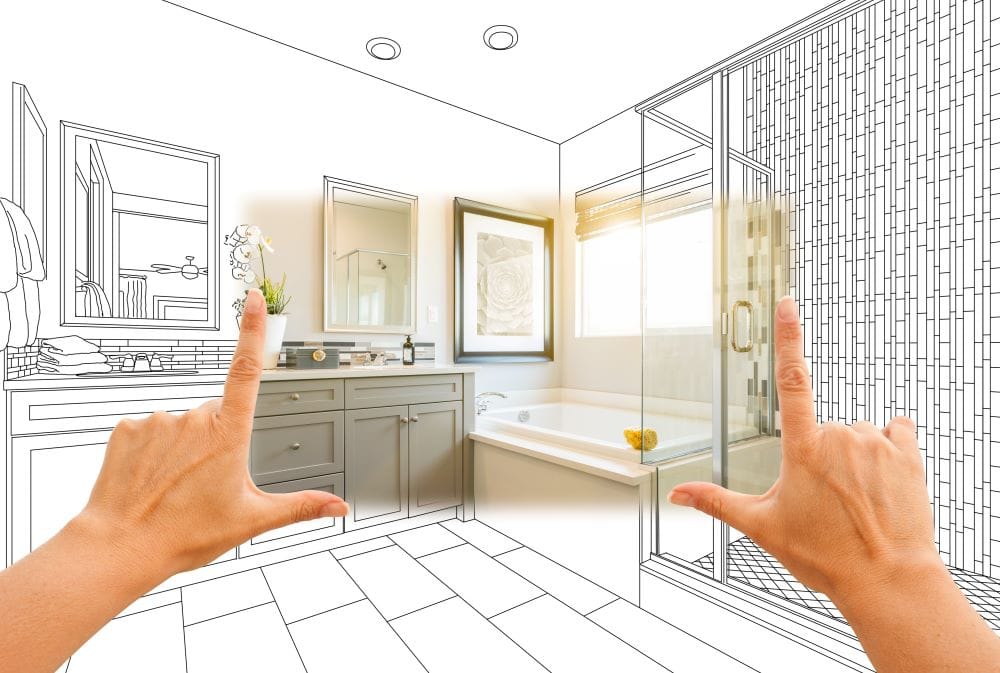 Individual holding a drawing of a bathroom, highlighting their creative vision and design ideas for the space.