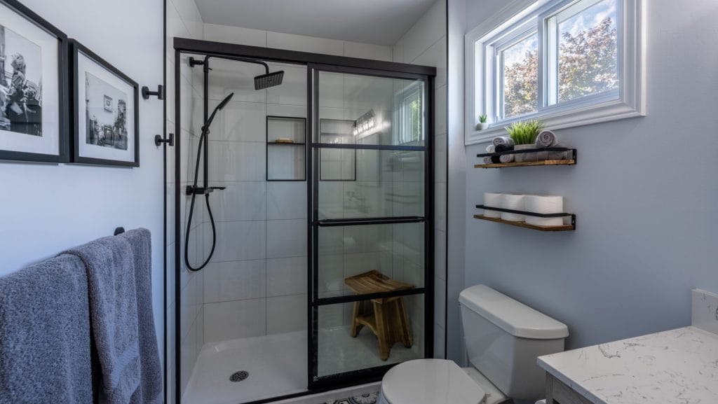 acrylic base tiled walls schluter niche black hardware Basement Bathroom renovation in Bells Corners